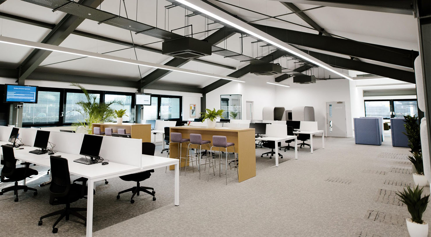 Allenby Commercial office full of desks, chairs and computers.