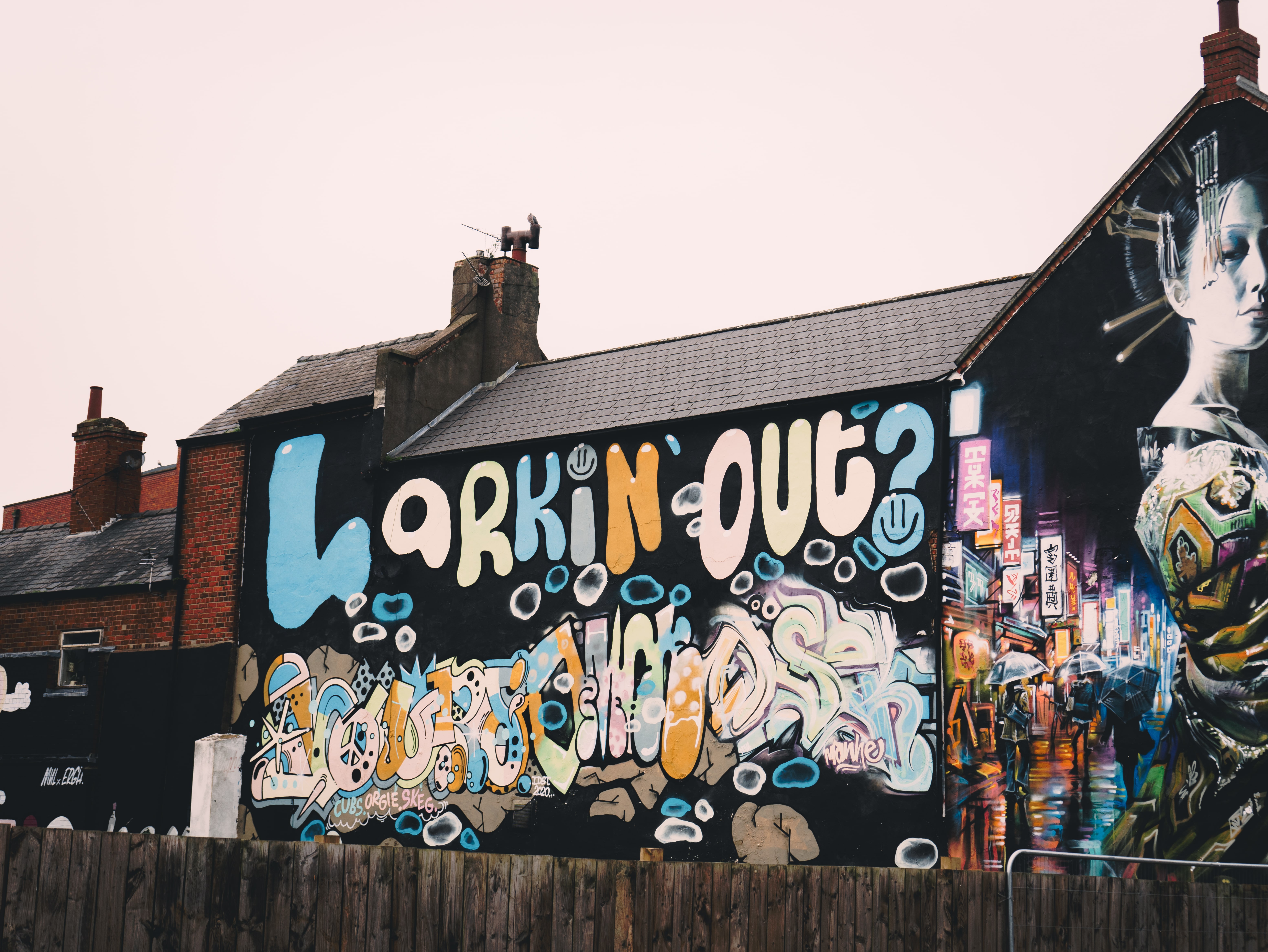 Graffiti on a wall that reads 'Larkin' out?'.